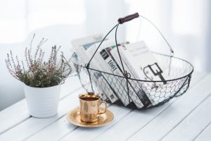 books in baskets potted plant and coffee cup